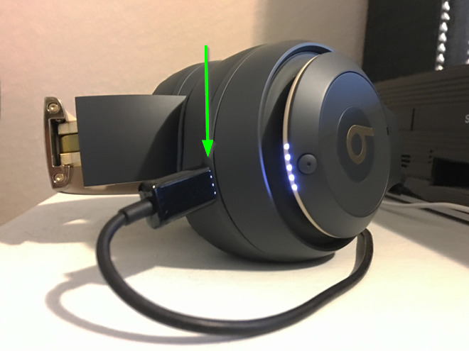 Picture of headphones charging with the power connection highlighted