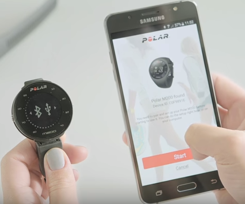 Polar m200 held next to an android phone showing them pairing
