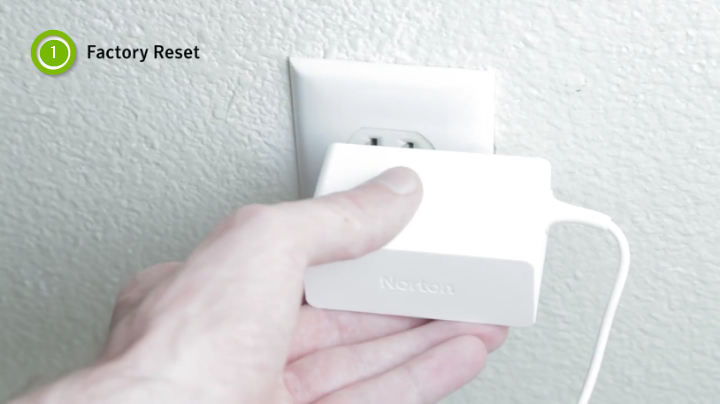 person holding plug in wall outlet