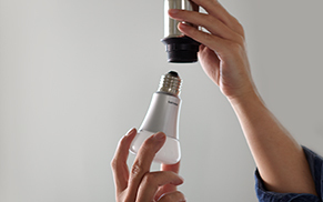 Screwing in Hue bulb.