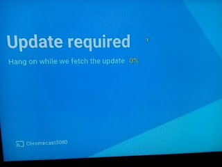 A chromecast image on a television showing that it is updating at 0 percent
