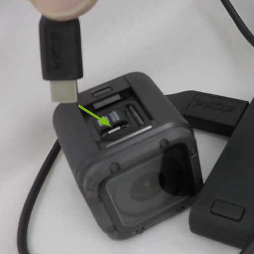 USB cable being plugged into GoPro USB slot.
