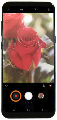 Camera app open with record button selected.