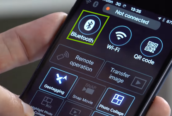 Bluetooth option highlighted on phone screen.