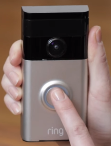picture of pressing the button on the doorbell