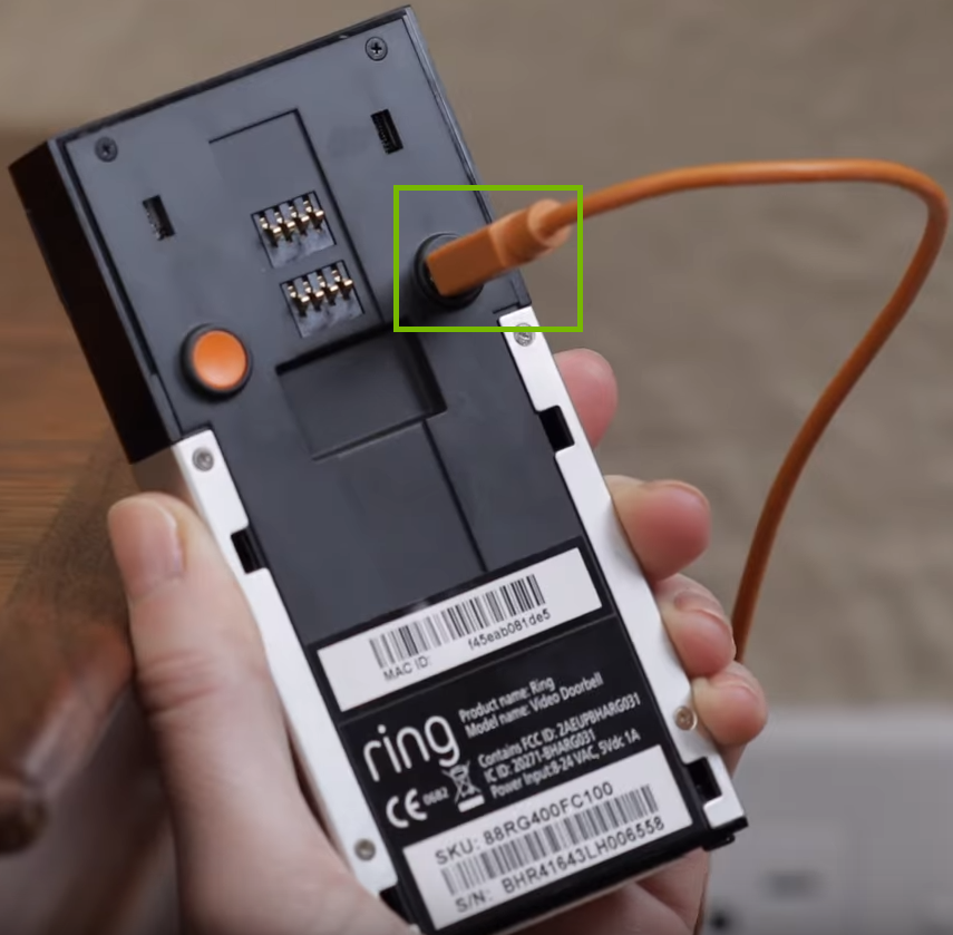 Picture of doorbell connected to USB cable to charge