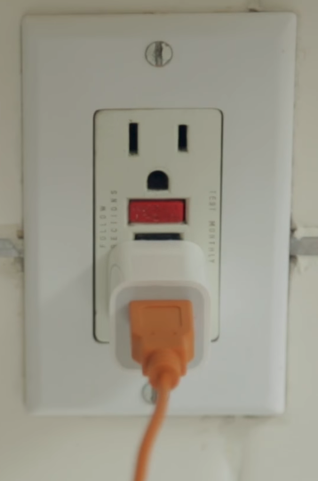 Ring camera's charger plugged into wall.