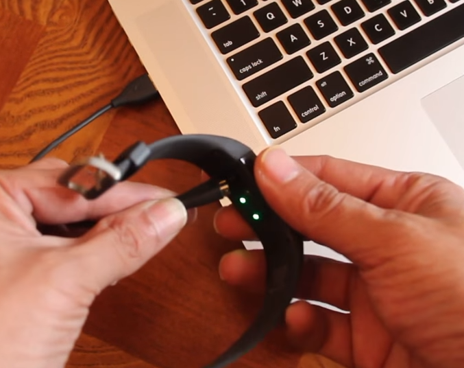 Fitbit Charge connected to computer USB port.