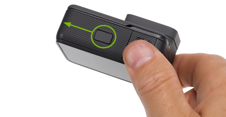 Battery compartment release button highlighted on bottom of camera