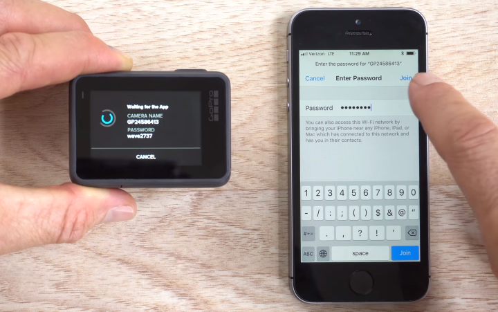 GoPro HERO6 next to a smartphone demonstrating the user entering the Wi-Fi password.