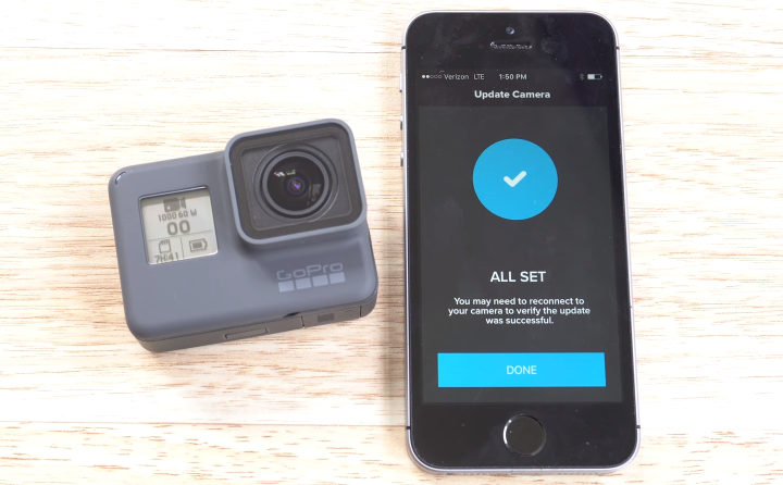 GoPro HERO6 having completed the update process, and a smartphone acknowledging the update was processed successfully.