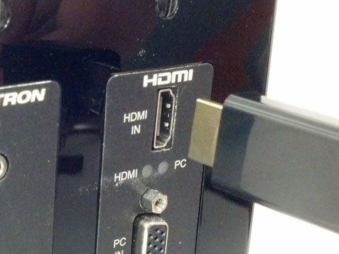 Inserting HDMI cable to back of TV