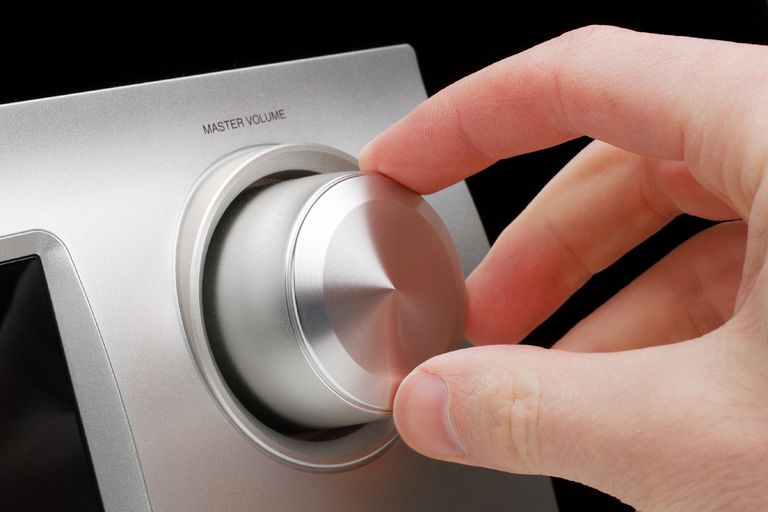 Adjusting a tuner volume knob.