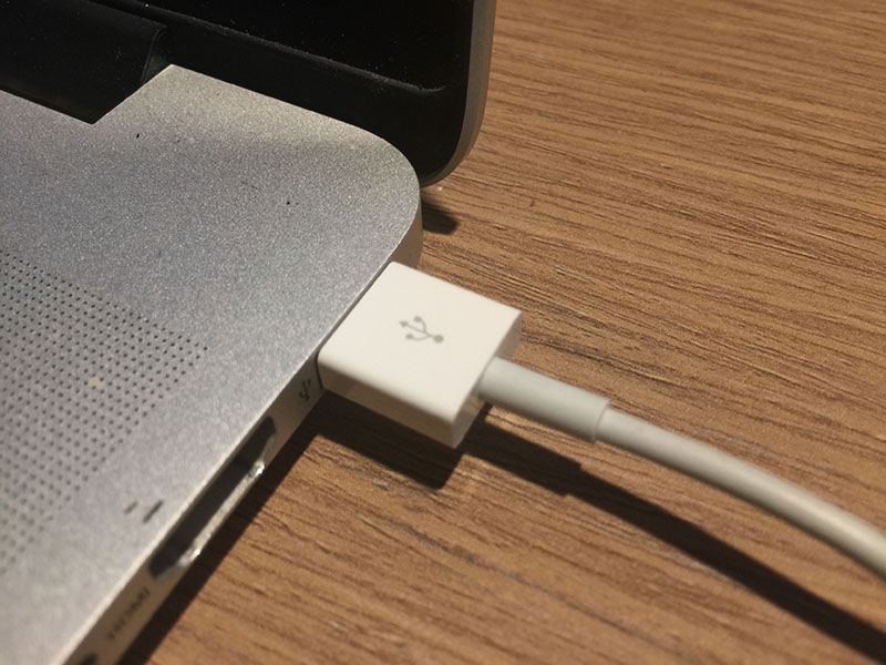 Magic Trackpad connected to a Mac via USB.