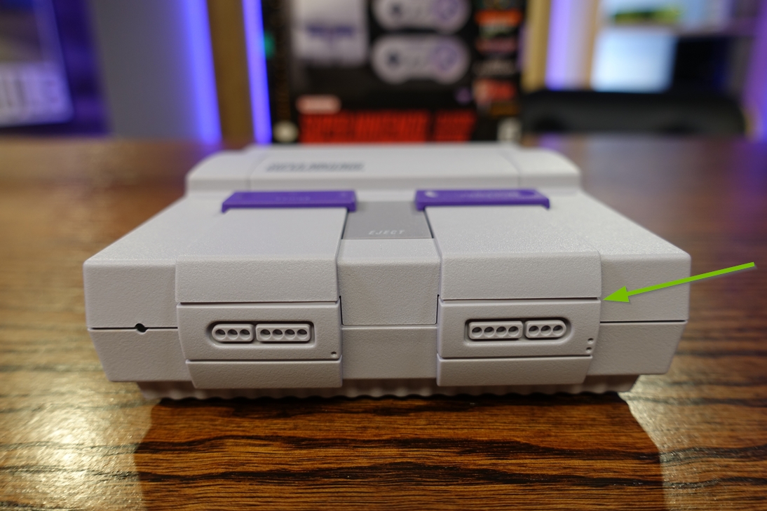 Photo of the SNES Classic Edition highlighting the front controller port cover while closed.