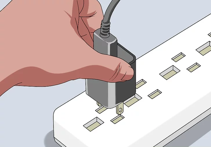 Image of a USB wall charger being inserted into a power outlet