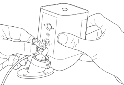 Plugging charging cable into rear of camera.