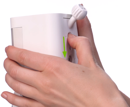 Mounting plate release button being pushed on rear of Ring camera.