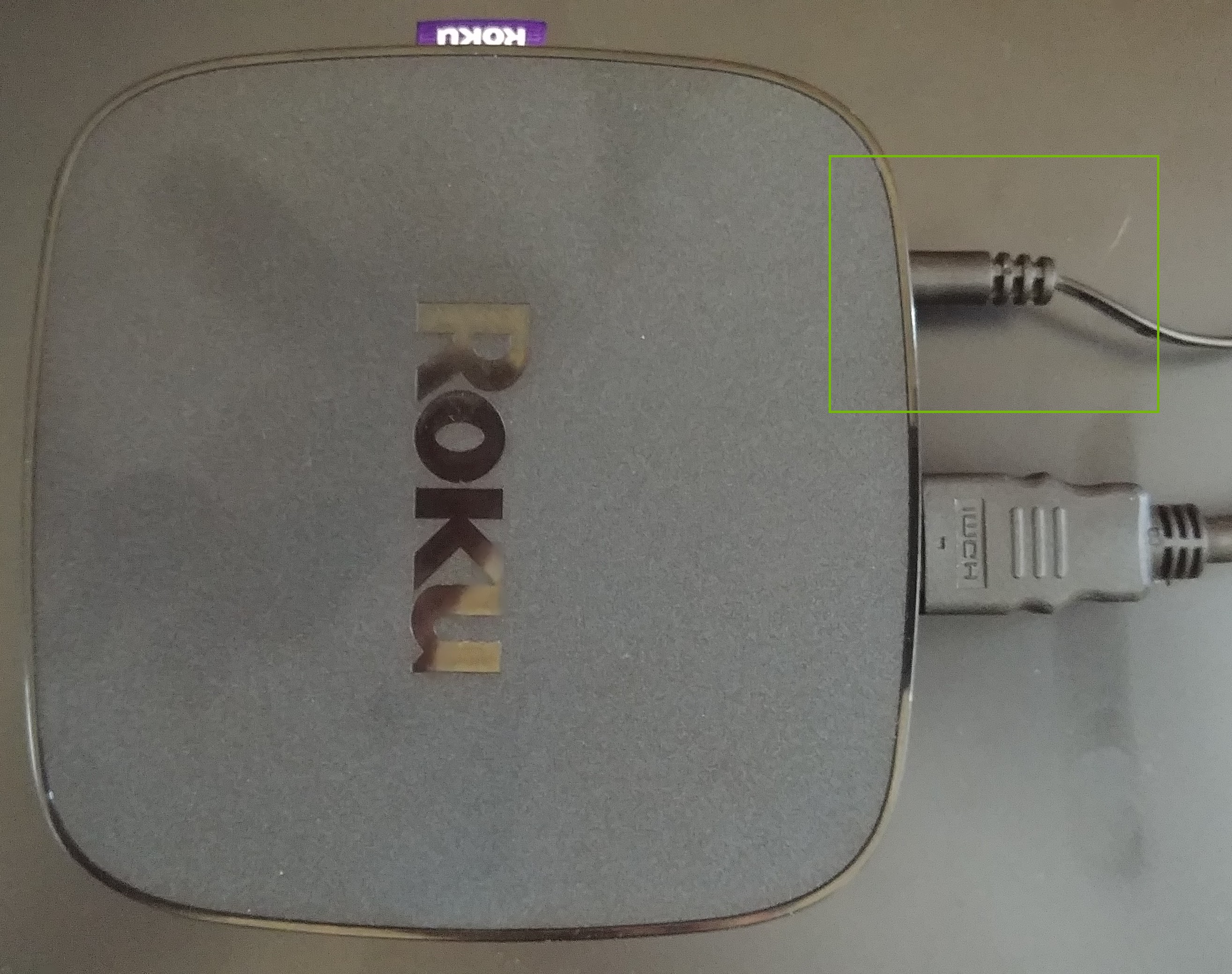 Roku with power cable plugged in.