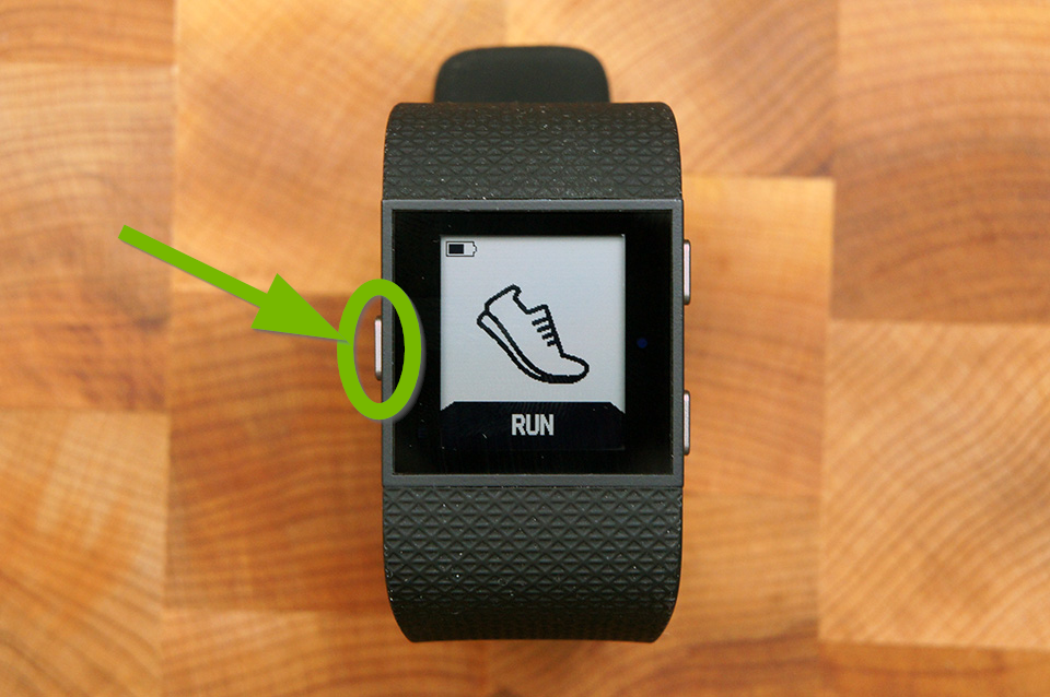 Fitbit Surge with Home button highlighted.