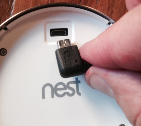 The back of a nest device showing the USB cable and slot