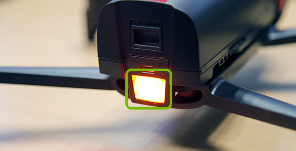 Drone with button on rear highlighted.