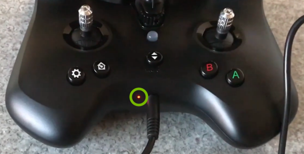 Battery charge indicator light highlighted in remote control.