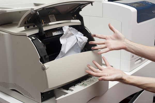 Stock photo of a printer with a paper jam.
