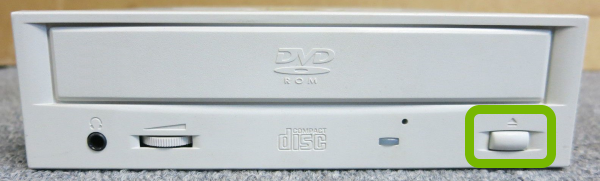 Eject button highlighted on disc drive.