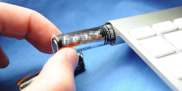 Inserting battery into Apple Wireless Keyboard.