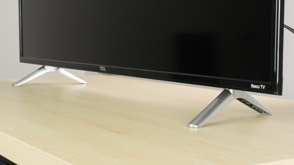 TCL Roku TV supported by stands.