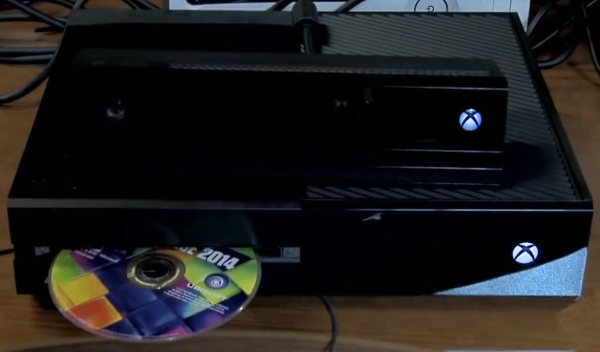 Disc being inserted in Xbox One console.