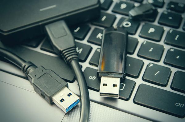 USB devices on top of a computer keyboard.