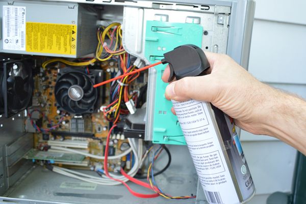 Using gas duster to clean inside a computer.