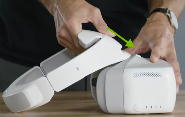 Arrow showing how to connect headband to goggles body.