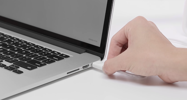 USB cable being plugged into computer.