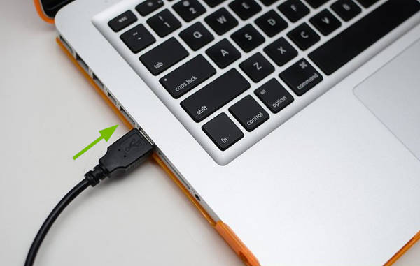 USB cable being plugged into Mac.