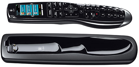 Logitech Harmony remote being placed onto its charging cradle.