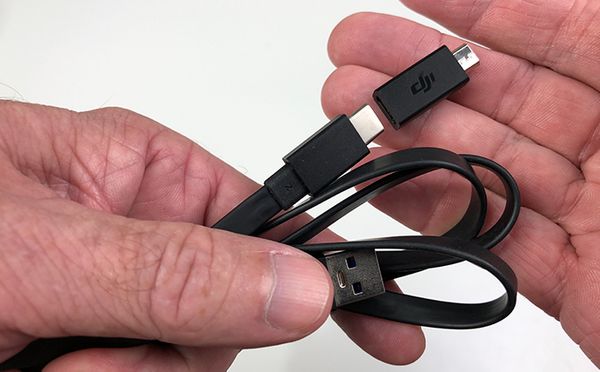 Micro USB adapter being attached to USB cable.