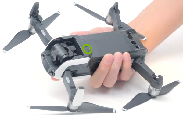Power button highlighted on bottom of drone.