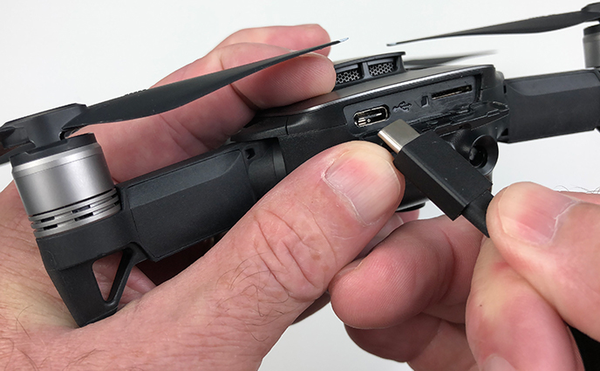 USB cable being plugged into drone.