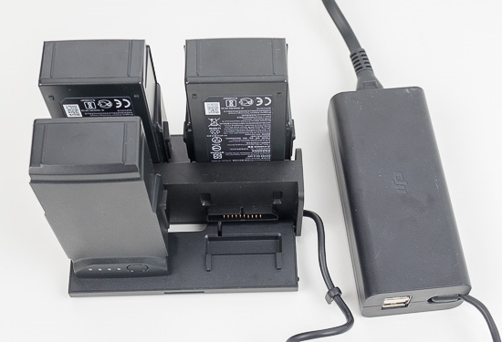 Drone batteries plugged into charging hub.