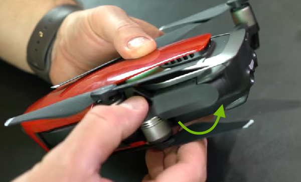 Arrow showing rear arm unfolding direction.