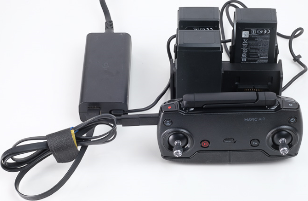 Remote control and charging hub connected to power adapter.