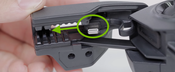 Side connector on RC highlighted and slide direction pointed out.