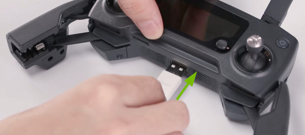 USB cable plugged into bottom of remote controller.