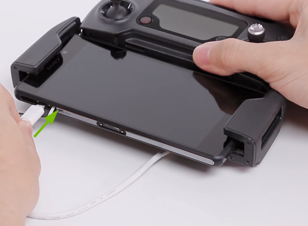 Micro USB connector being plugged into side mobile device.