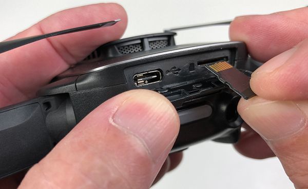 microSD card being inserted into the Mavic Air drone.