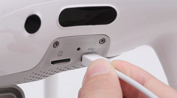 USB cable being plugged into drone.