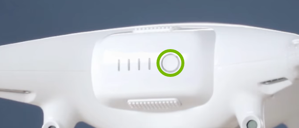 Power button highlighted on rear of drone.